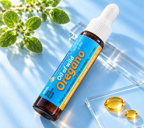 Solutions4Health Oil of Wild Oregano 10ml travel bottle with fresh oregano and golden oil droplets on a light blue background.