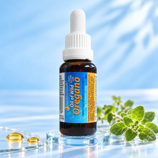 Solutions4Health Oil of Wild Oregano 25ml bottle on a glass base with fresh oregano and golden oil droplets against a light blue background.
