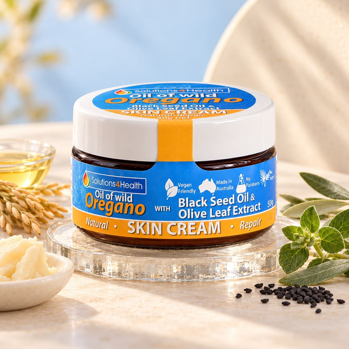 Solutions4Health Oil of Wild Oregano Skin Cream 50g with black seed oil and olive leaf extract, surrounded by botanical ingredients.